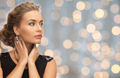 stock-photo-76750199-beautiful-woman-wearing-earrings-over-lights